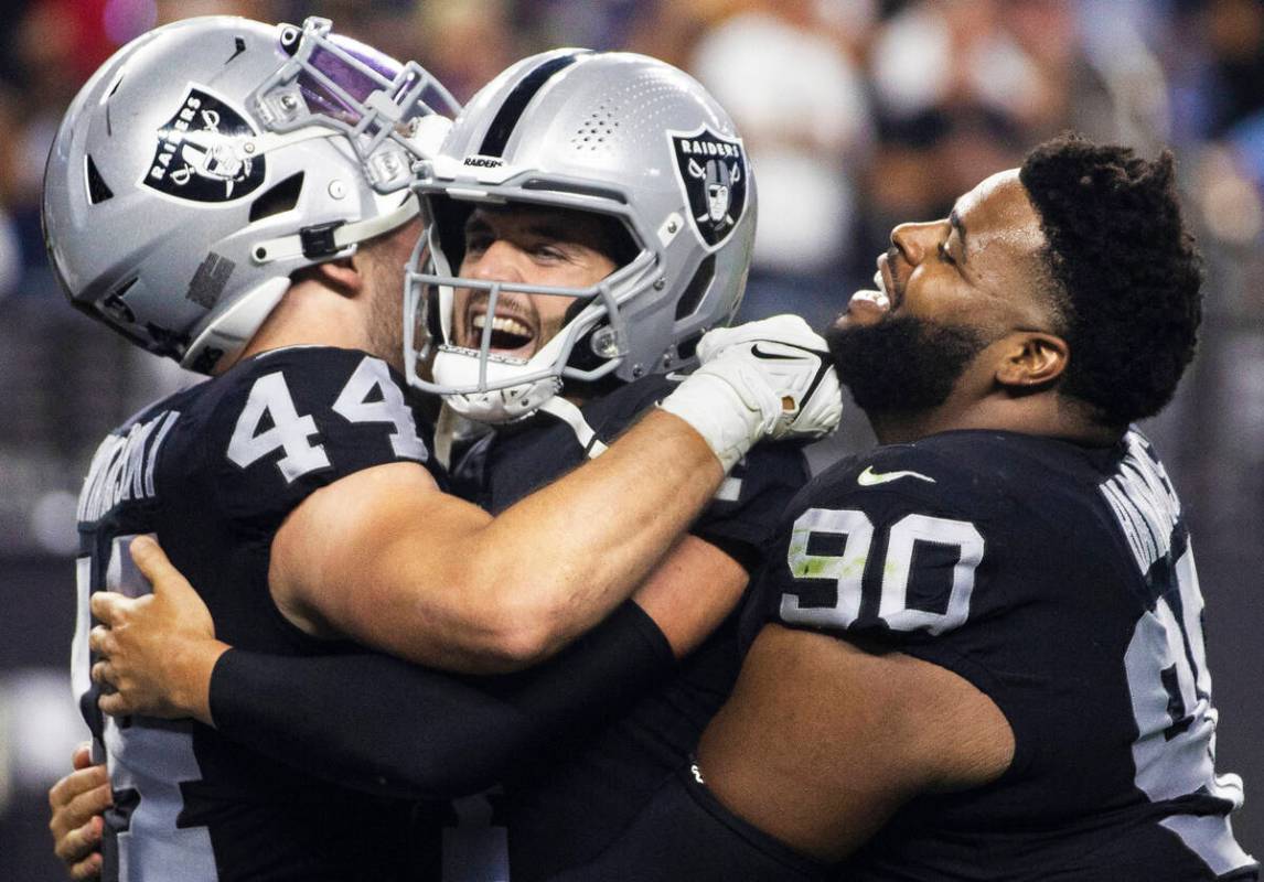 Raiders quarterback Derek Carr (4) celebrates a big play with Raiders inside linebacker Nick Kw ...