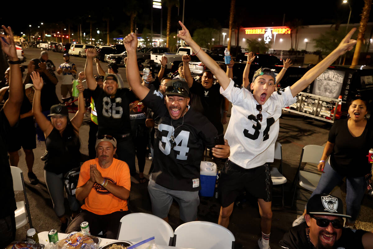 Tailgating fans, including Marcus Camarena, right, and Tony "Tony Vegas" Ocoro, both ...