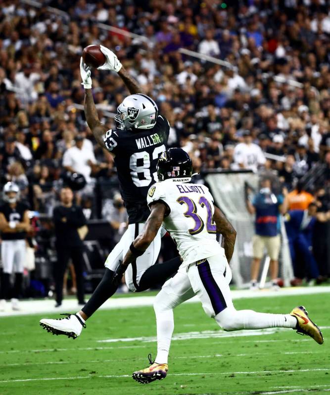 Raiders tight end Darren Waller (83) catches a pass as Baltimore Ravens defensive back DeShon E ...