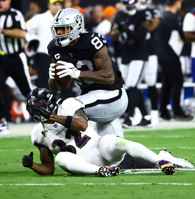 Raiders tight end Darren Waller (83) carries a ball as Baltimore Ravens defensive back DeShon E ...