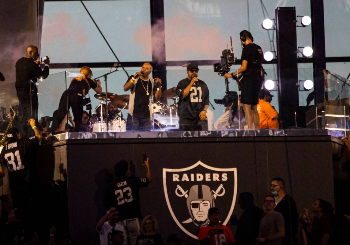 Too Short, center left, and Ice Cube perform during halftime at an NFL game between the Raiders ...