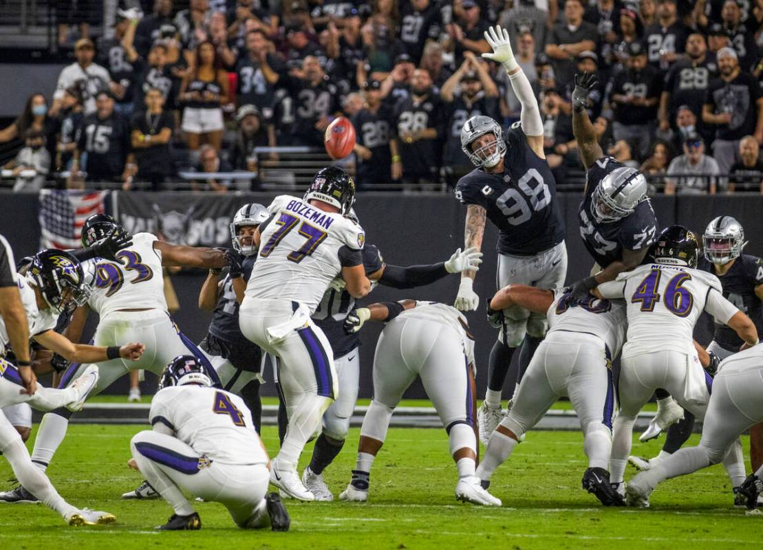 Raiders defensive end Maxx Crosby (98) gets up high to attempt a field goal block during the th ...