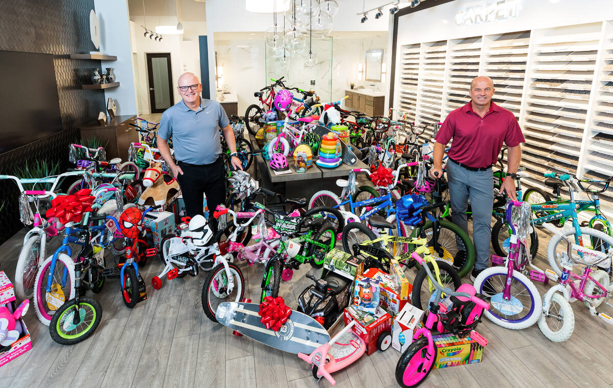 Chet Buchanan, left, 98.5 KLUC DJ whose annual Toy Drive to benefit HELP of Southern Nevada is ...