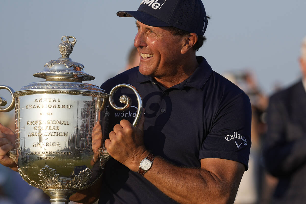 Phil Mickelson holds the Wanamaker Trophy after winning the final round at the PGA Championship ...