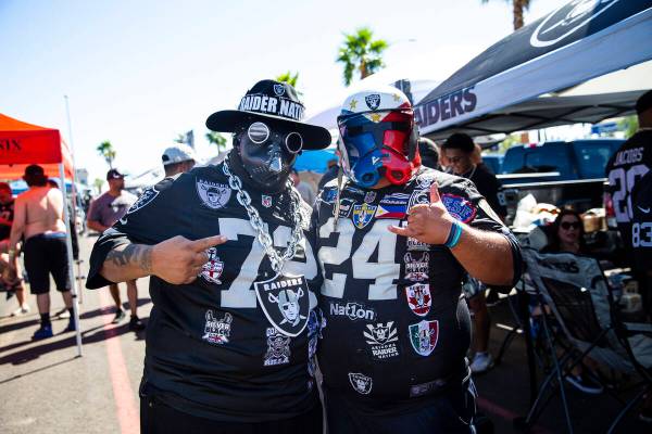 Raiders fans Phillip Prieto, left, and Gene Biyok pose for a portrait during a tailgate before ...