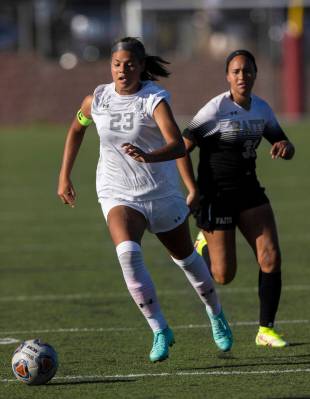 Arbor View’s Tiana Beavers (23) pushes the ball up field past Faith Lutheran’s Br ...