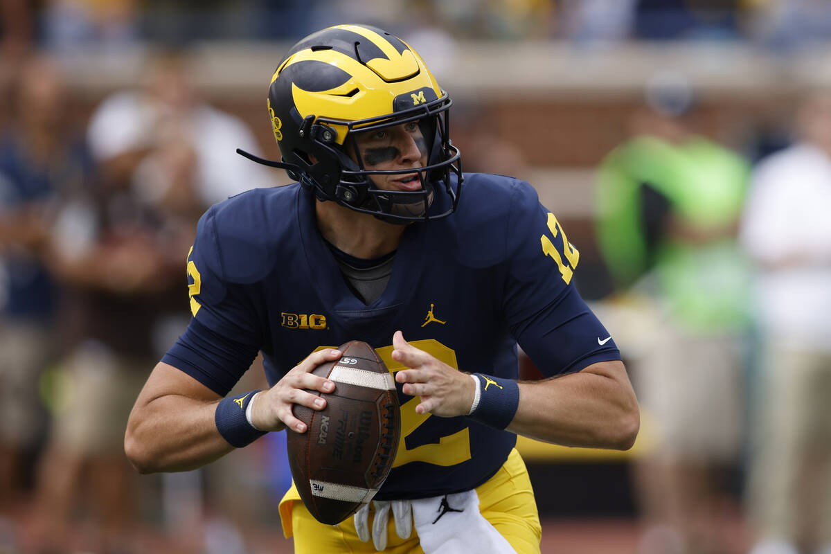 Michigan quarterback Cade McNamara plays against Western Michigan during an NCAA football game ...