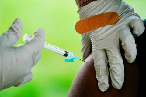 In this Sept. 14, 2021, file photo, a health worker administers a dose of a Pfizer COVID-19 vac ...