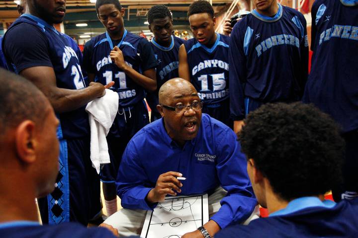 Canyon Springs head coach Freddie Banks talks to his team during a time-out against Valley High ...