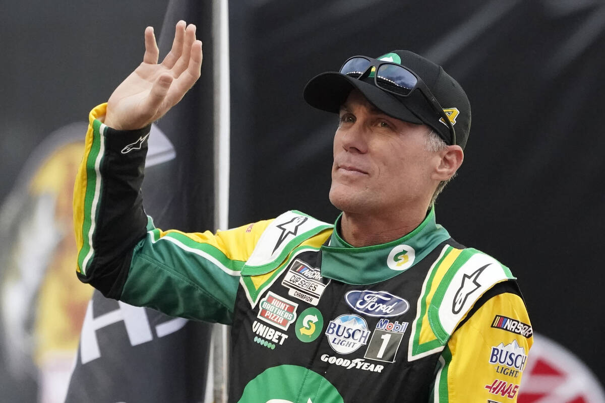 Kevin Harvick waves to fans before a NASCAR Cup Series auto race at Bristol Motor Speedway Satu ...