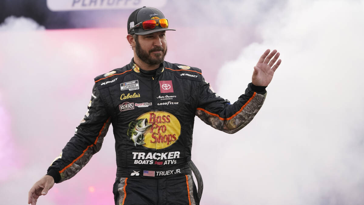 Martin Truex Jr. waves to the crowd during driver introductions prior to the start of the NASCA ...
