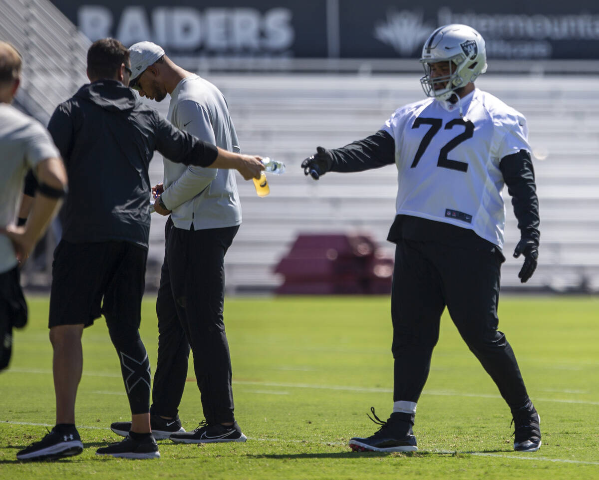 Raiders offensive tackle Jermaine Eluemunor (72) grabs a water during team practice at the Raid ...