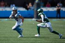 Carolina Panthers running back Christian McCaffrey (22) tries to avoid the tackle attempt of Ne ...