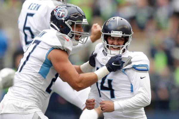Tennessee Titans kicker Randy Bullock, right, celebrates with tight end Geoff Swaim, left, afte ...