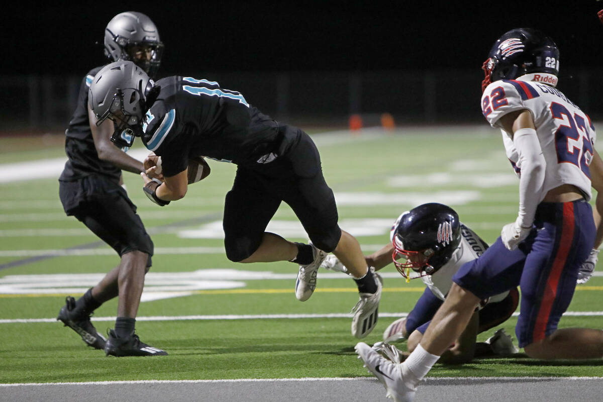 Silverado High School's Brandon Tunnell (11) scores a touchdown over Coronado High School's Pre ...
