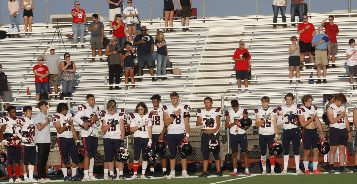 Coronado High School's players stand for the national anthem before a football game against Sil ...