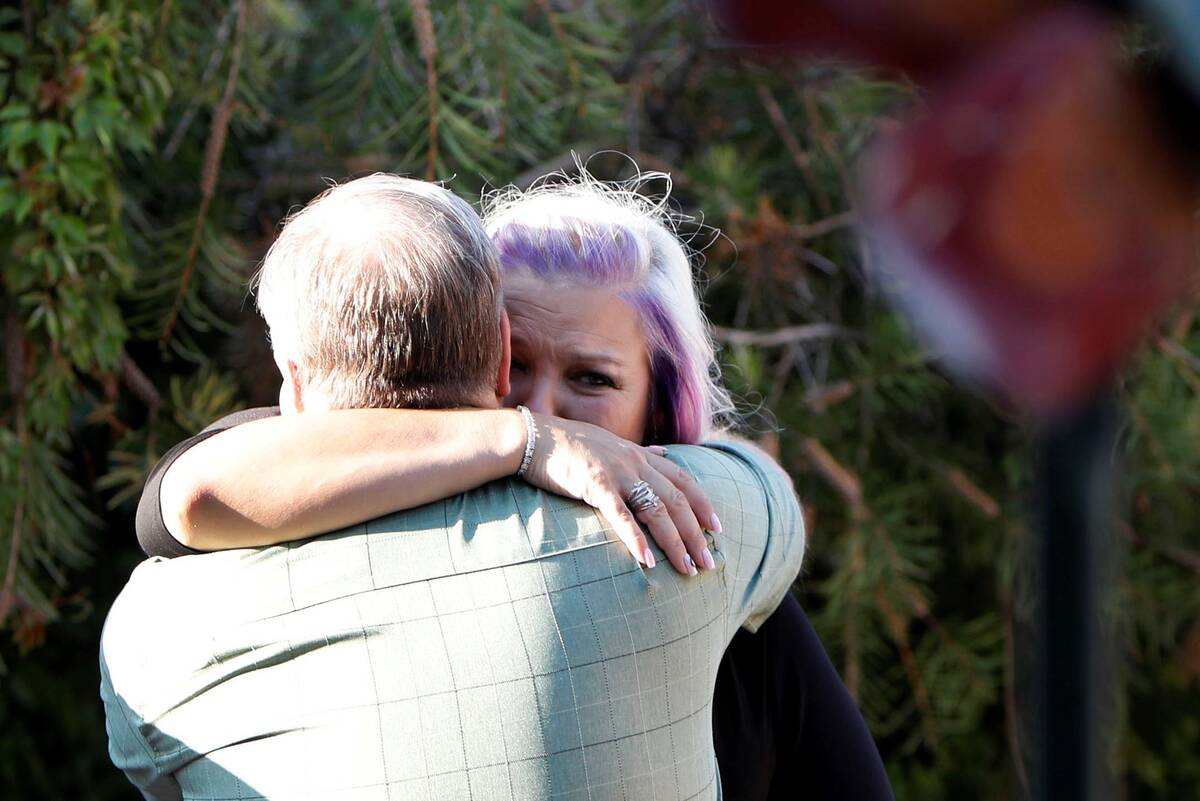 Kristin Bell-Peistrup, face to camera, hugs Mark Jennings of Las Vegas during a celebration of ...