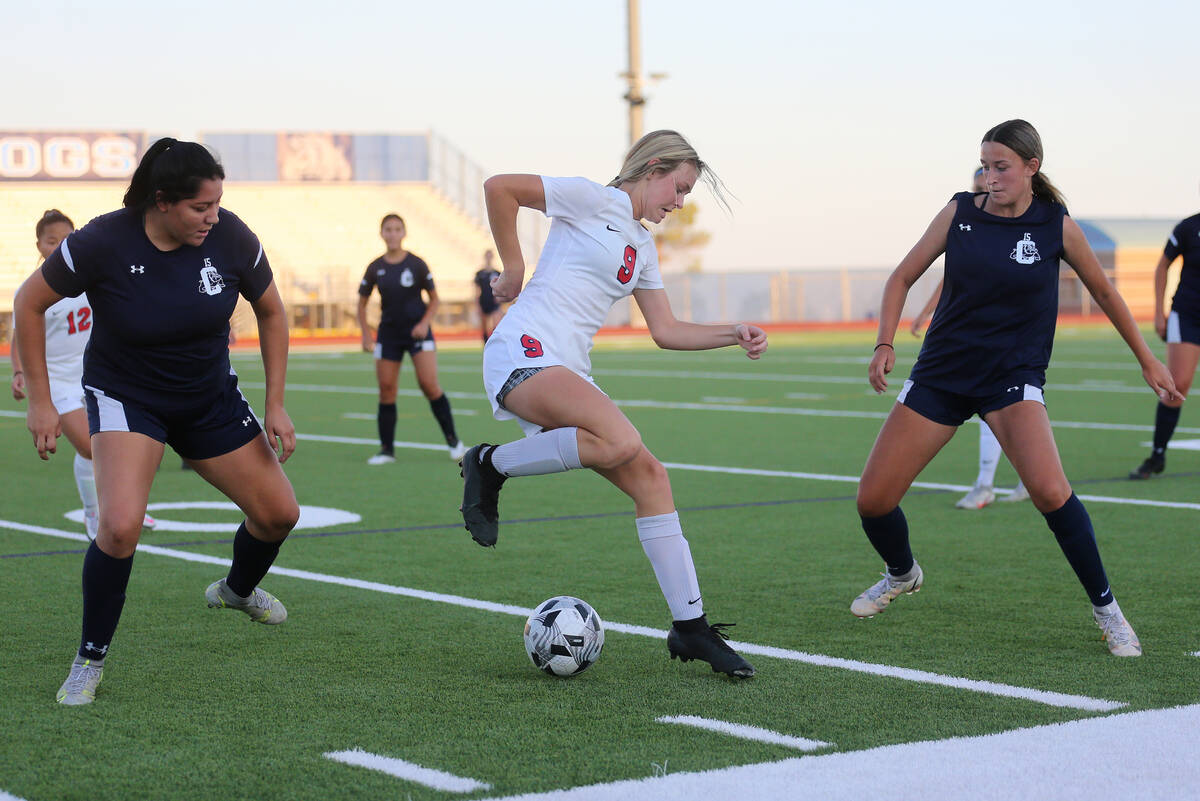 Coronado's Molly Russell (9) dibbles the ball away from Centennial's Keyla Alba (23) and Gabrie ...