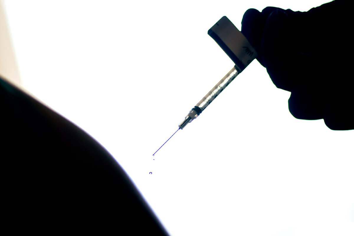 FILE - In this Dec. 15, 2020, file photo, a droplet falls from a syringe after a person was inj ...