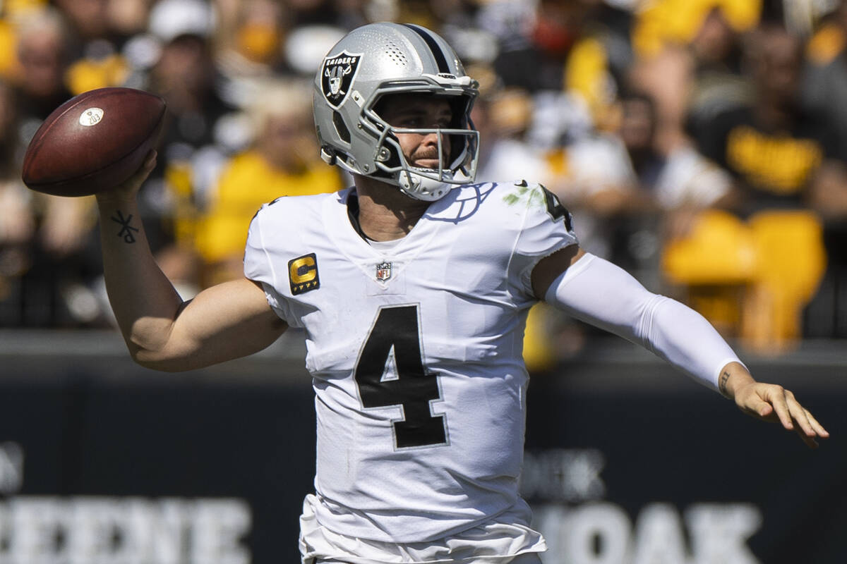 Raiders quarterback Derek Carr (4) makes a sideline pass with Pittsburgh Steelers cornerback Ja ...