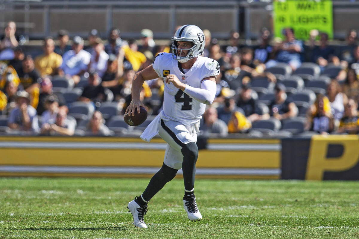 Raiders quarterback Derek Carr (4) scrambles with the football during the third quarter of an N ...