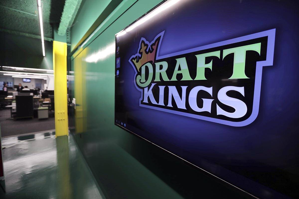 FILE - In this May 2, 2019, file photo, the DraftKings logo is displayed at the sports betting ...