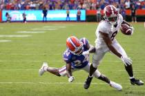 Alabama wide receiver John Metchie III (8) makes a move to get around Florida cornerback Avery ...