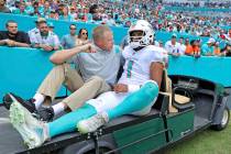 Miami Dolphins quarterback Tua Tagovailoa (1) carted out the field after getting injured in a p ...