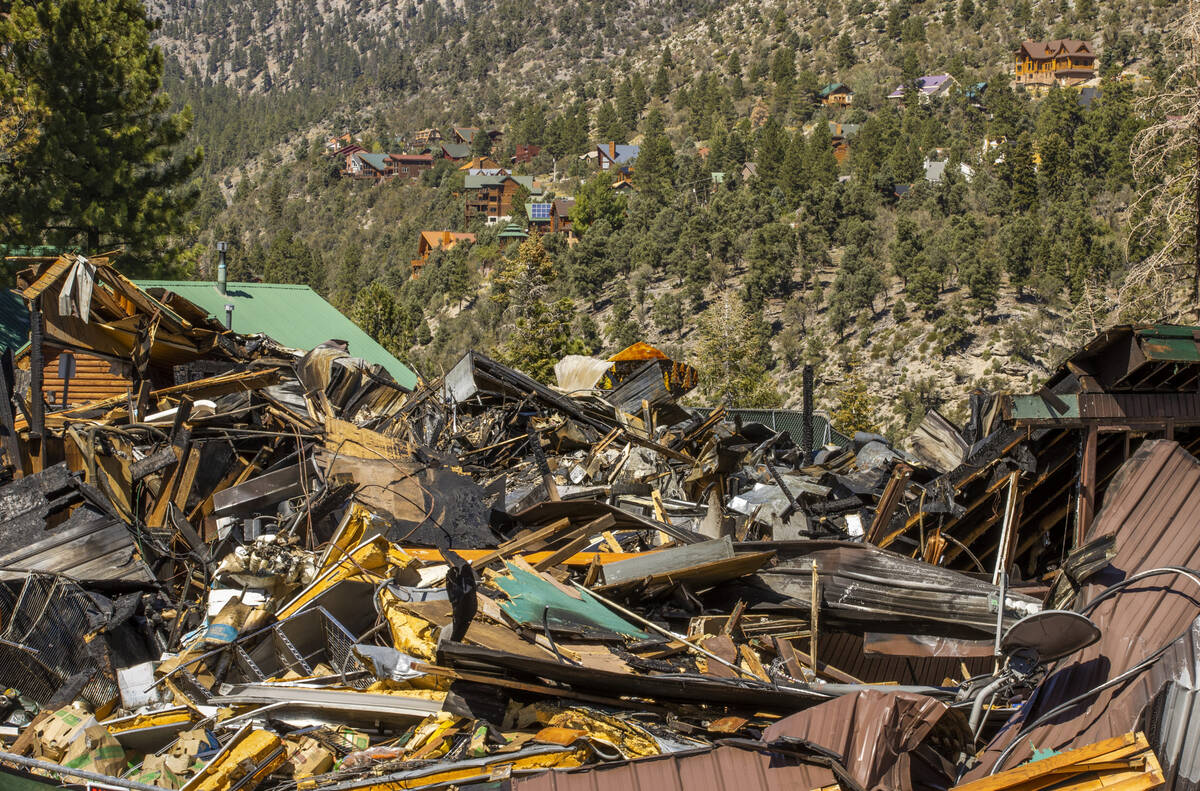 The burned remains of the Mount Charleston Lodge with homes in the hills above it Wednesday, Se ...