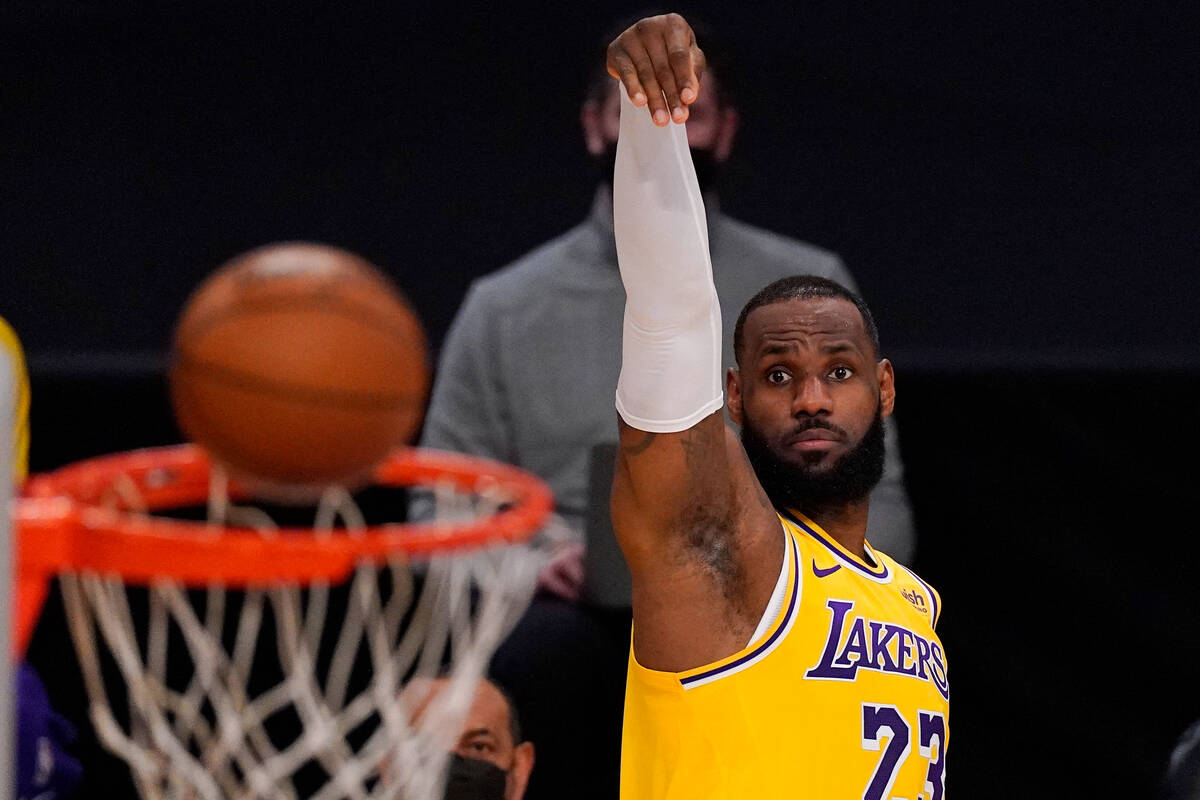 Los Angeles Lakers forward LeBron James shoots during the first half of an NBA basketball game ...