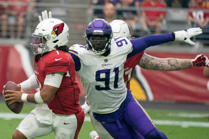 Arizona Cardinals' Kyler Murray 1,runs away from Minnesota Vikings' Stephen Weatherly 91, durin ...