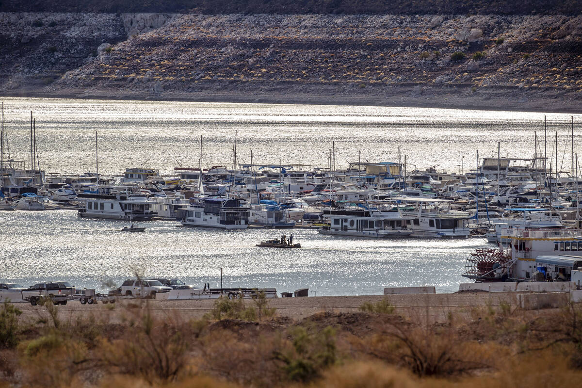 Boats cruise on a sunlit morning in Hemenway Harbor at the Lake Mead National Recreation Area o ...
