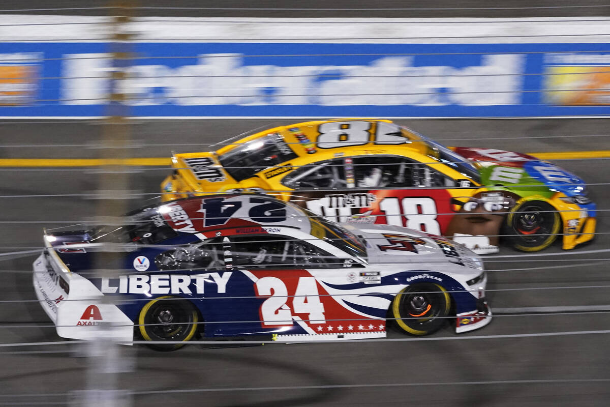 William Byron (24) and Kyle Busch (18) race into turn one during the NASCAR Cup series auto rac ...
