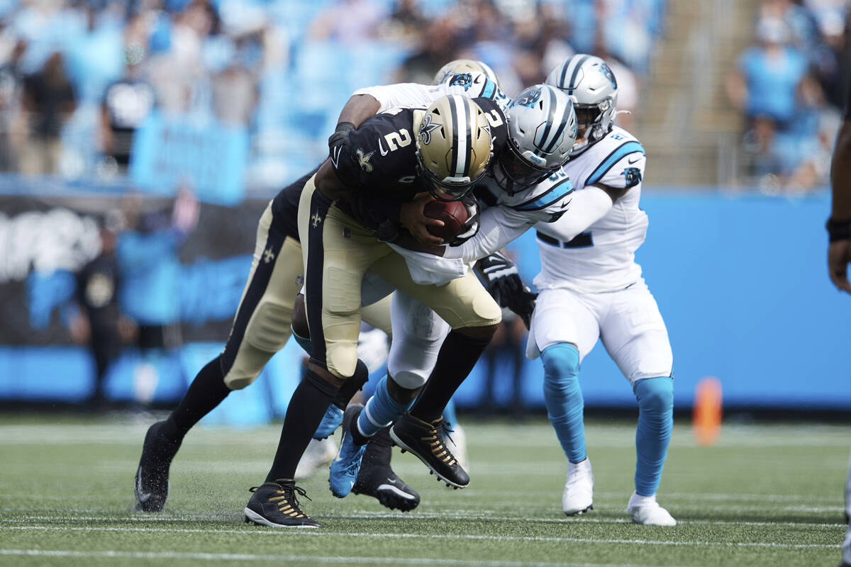 New Orleans Saints quarterback Jameis Winston (2) is sacked by Carolina Panthers defensive end ...