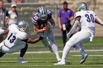 Kansas State quarterback Will Howard (15) runs between Nevada defensive back Jordan Lee (13) an ...