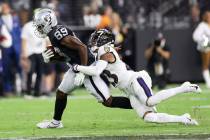 Raiders wide receiver Bryan Edwards (89) is tackled by Baltimore Ravens cornerback Anthony Aver ...