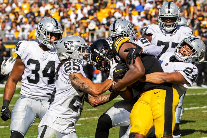 Raiders defensive back Johnathan Abram (24), Raiders safety Trevon Moehrig (25) and Raiders out ...