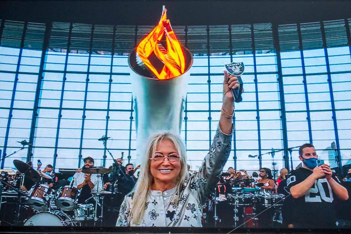 Dr. Miriam Adelson lights the Al Davis Memorial Torch Flame before the starts of a NFL preseaso ...