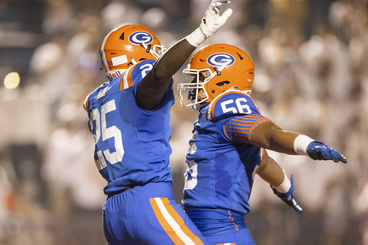 Bishop Gorman's William Stallings Jr (25) celebrates his touchdown with Zak Yamauchi (56) durin ...