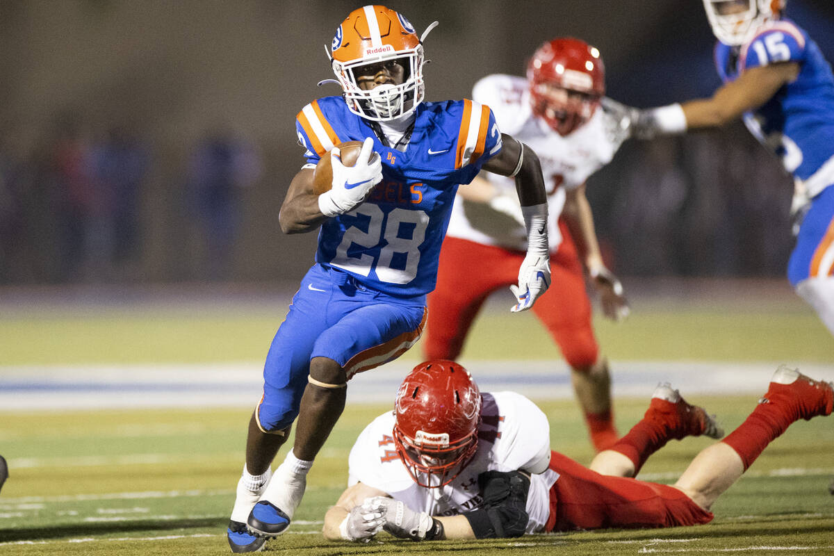 Bishop Gorman's Devon Rice (28) runs the ball against Arbor View in the first half of a footbal ...