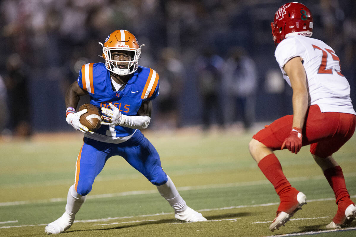 Bishop Gorman's Zachariah Branch (1) runs the ball against Arbor View's Tanner Aitken (25) duri ...