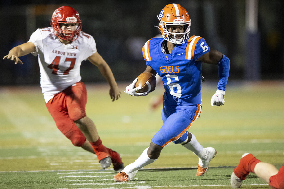 Bishop Gorman's Jonathan Brady (6) returns a punt under pressure from Arbor View's Bryce Ericso ...