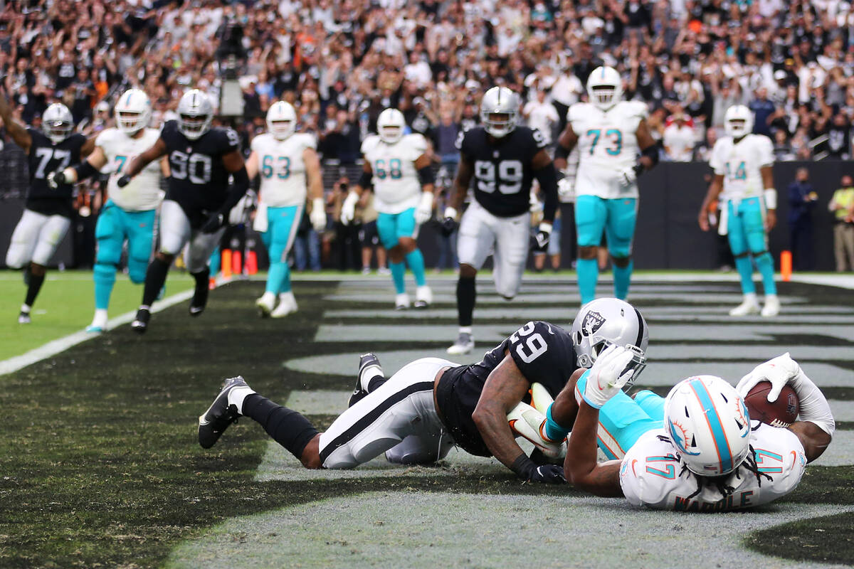 Las Vegas Raiders cornerback Casey Hayward (29) tackles Miami Dolphins wide receiver Jaylen Wad ...