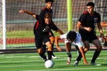 Las Vegas' Keaton McCoy (13) moves the ball as Coronado's Isaac Carcamo tries to keep up during ...