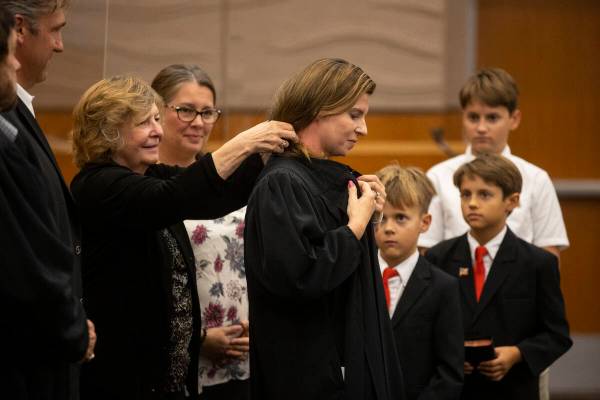 Rita Sisinger robes her daughter Judge Veronica Barisich during the Eight Judicial District Cou ...