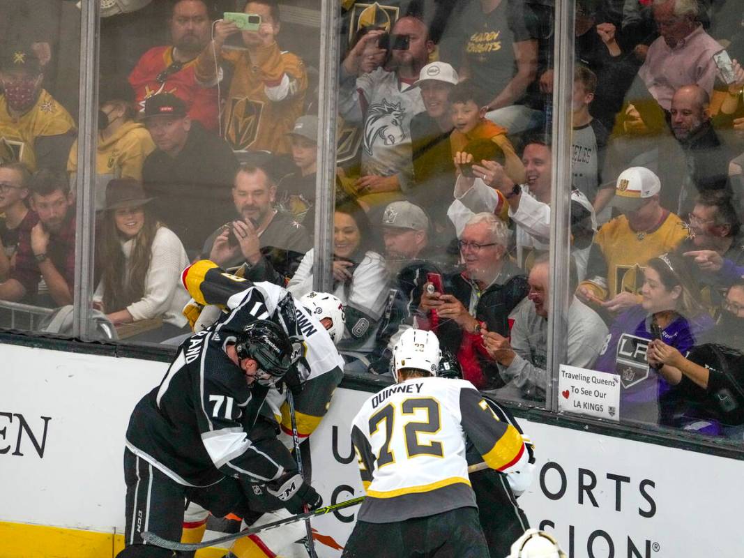 Fans try to get photos of a scrum as the Los Angeles Kings and the Vegas Golden Knights meet in ...