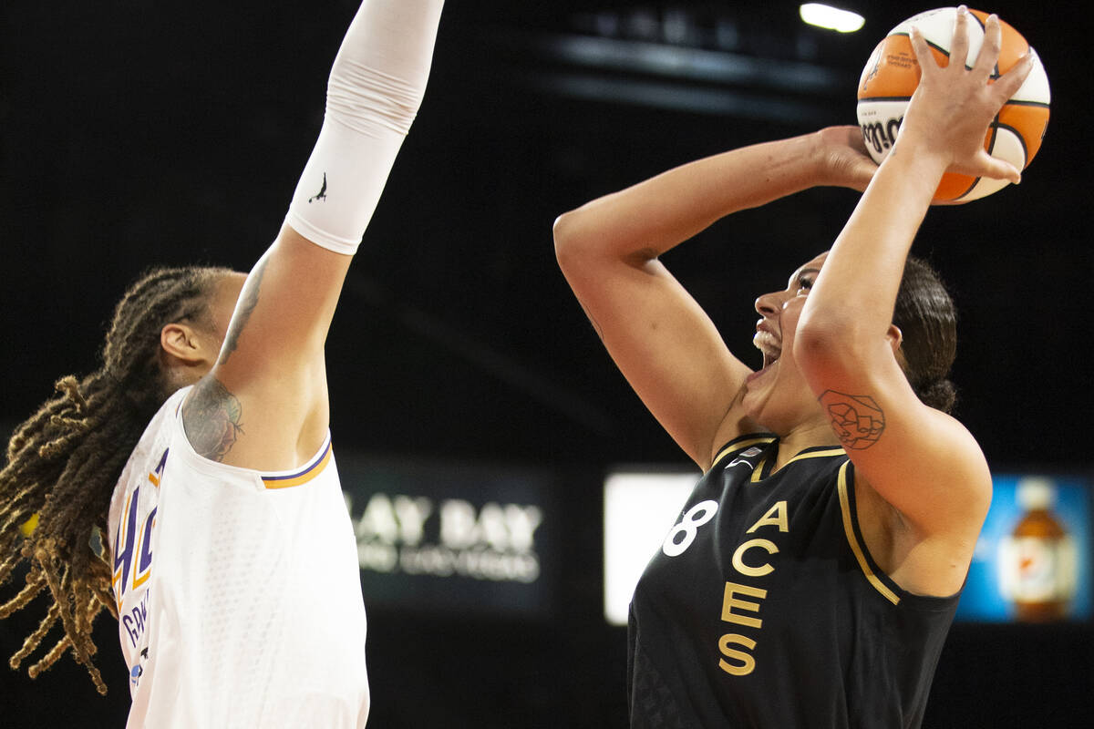 Las Vegas Aces center Liz Cambage (8) jumps to shoot while Phoenix Mercury center Brittney Grin ...