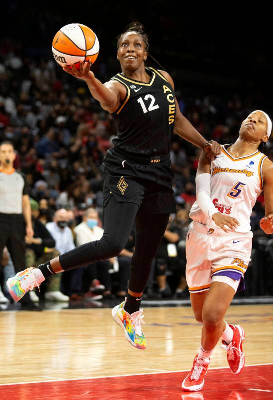 Las Vegas Aces guard Chelsea Gray (12) jumps to shoot a layup as Phoenix Mercury guard Shey Ped ...