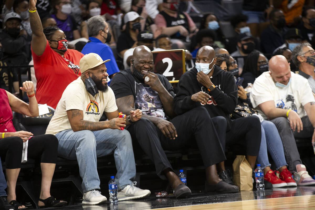 Shaquille O'Neal, center, laughs while attending game 2 of a WNBA semifinal game between the La ...