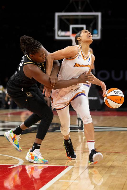 Las Vegas Aces guard Chelsea Gray (12) reaches for the ball as Phoenix Mercury guard Skylar Dig ...